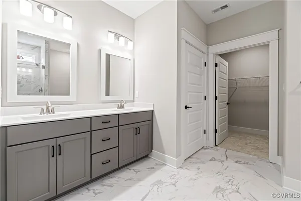 a bathroom with a shower sink and mirror