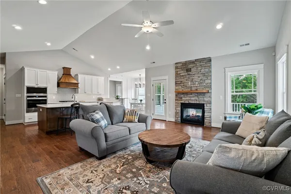 a living room with furniture fireplace and kitchen view