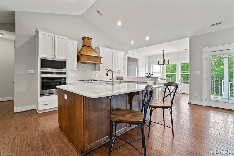 Lot 44 Wendenburg Circle, Unit SPEC Aylett, VA 23009 - Photo 10 of 19 a kitchen with stainless steel appliances a stove a sink a microwave a dining table and chairs