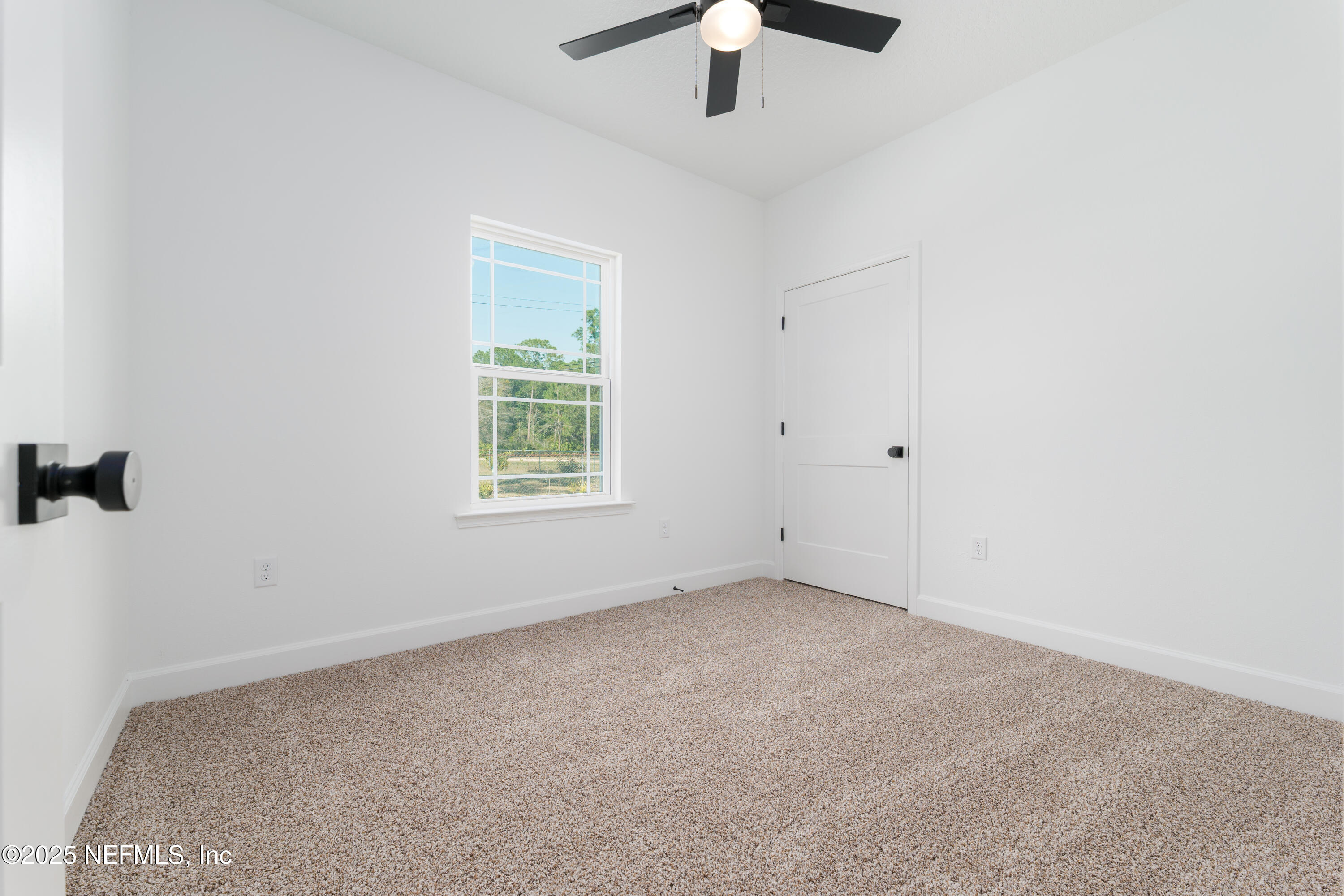 5214 County Road 218 Middleburg, FL 32068 - Photo 19 of 30 an empty room with a chandelier fan and windows