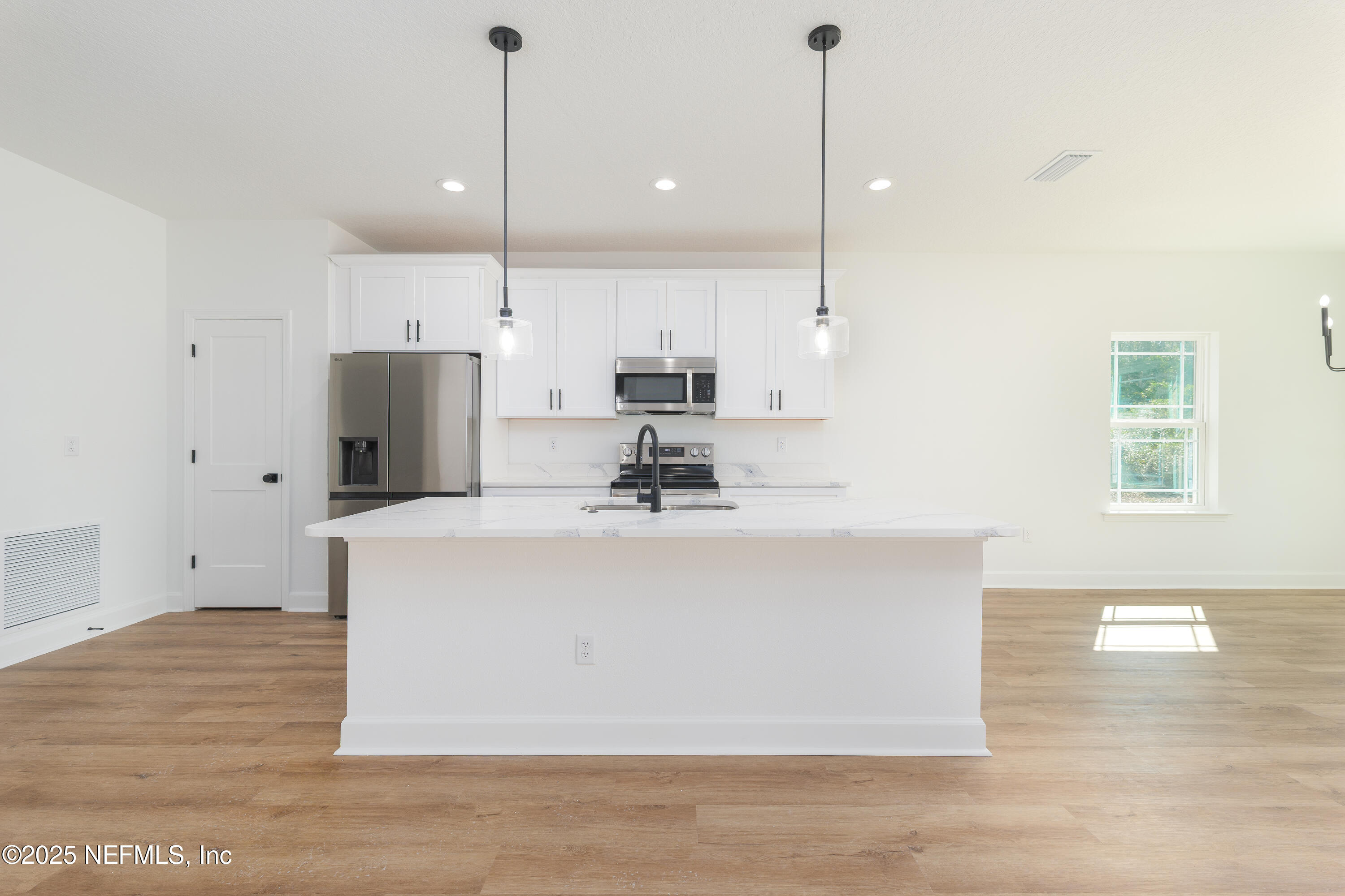 5214 County Road 218 Middleburg, FL 32068 - Photo 5 of 30 a view of kitchen with stainless steel appliances granite countertop cabinets and wooden floor