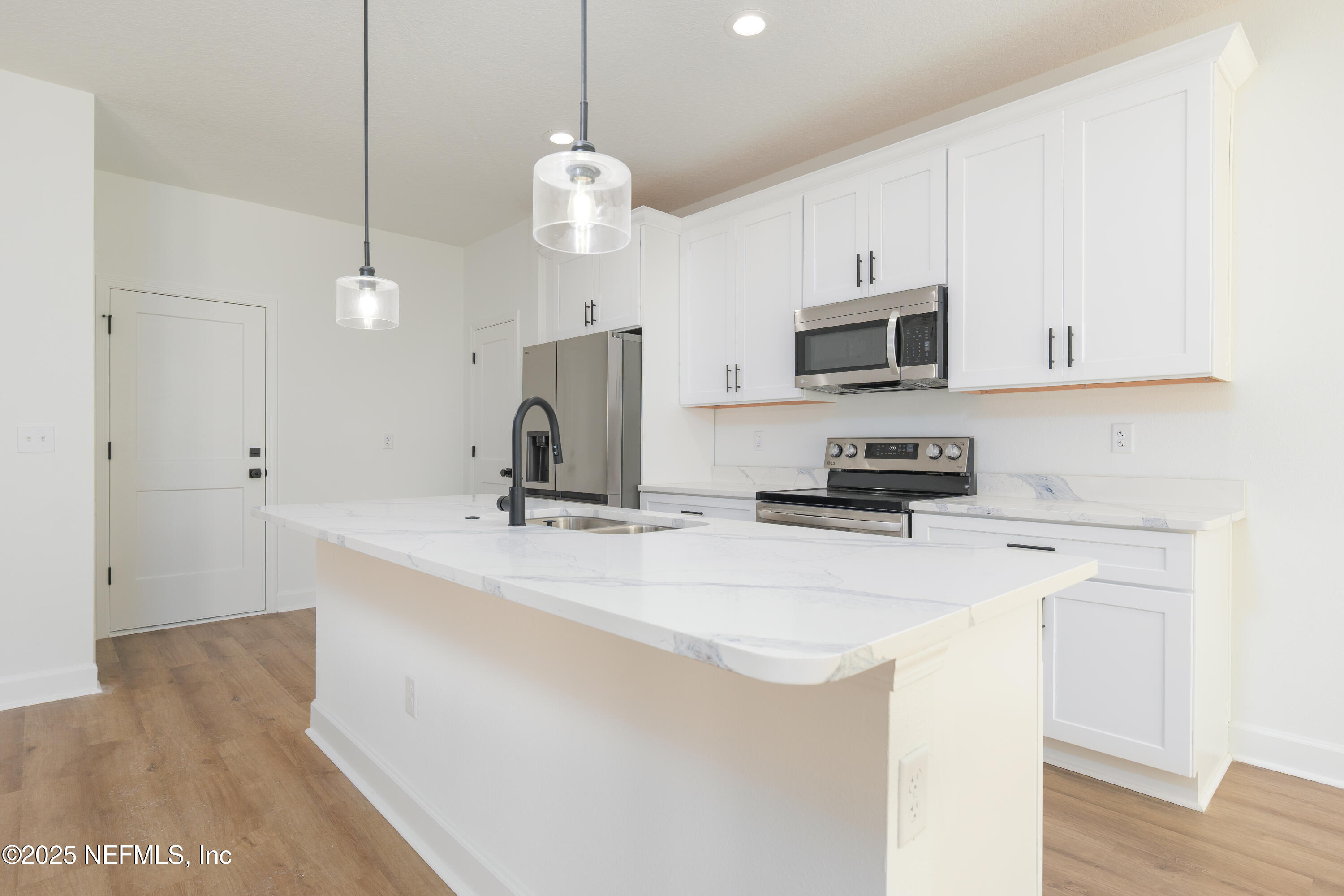 5214 County Road 218 Middleburg, FL 32068 - Photo 8 of 30 a kitchen with stainless steel appliances a stove a sink and a refrigerator