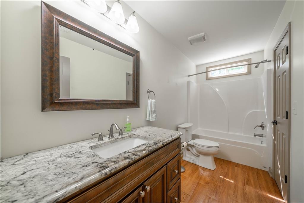25 Quail Ridge Road Taylorsville, GA 30178 - Photo 17 of 29 a bathroom with a granite countertop sink a mirror and a bathtub