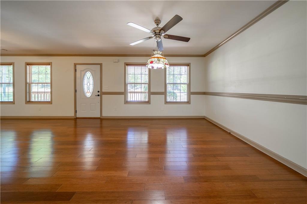 25 Quail Ridge Road Taylorsville, GA 30178 - Photo 5 of 29 a view of an empty room with wooden floor and a window