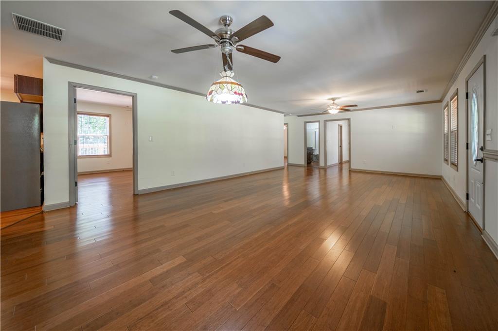25 Quail Ridge Road Taylorsville, GA 30178 - Photo 6 of 29 a view of an empty room with wooden floor and a ceiling fan