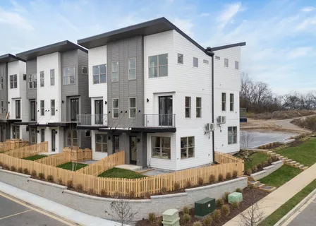 a living room with stainless steel appliances kitchen island granite countertop furniture and a view of living room
