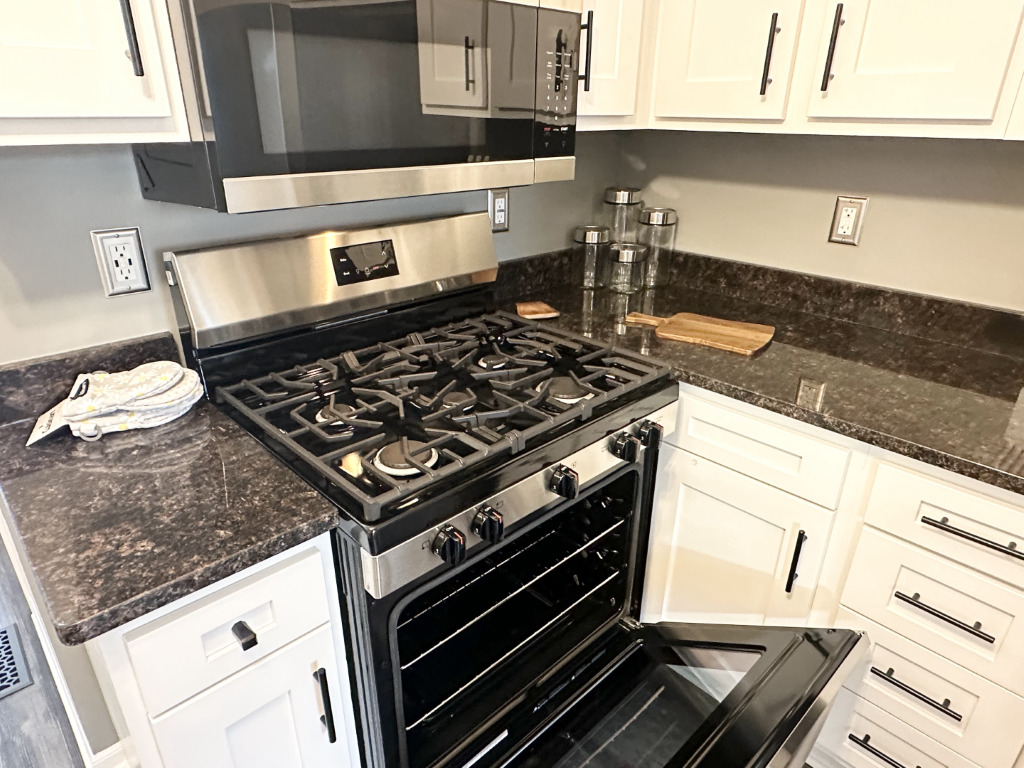 1514 Northfield Meadows Boulevard, Unit 2 Bourbonnais, IL 60914 - Photo 15 of 30 a stove top oven sitting inside of a kitchen