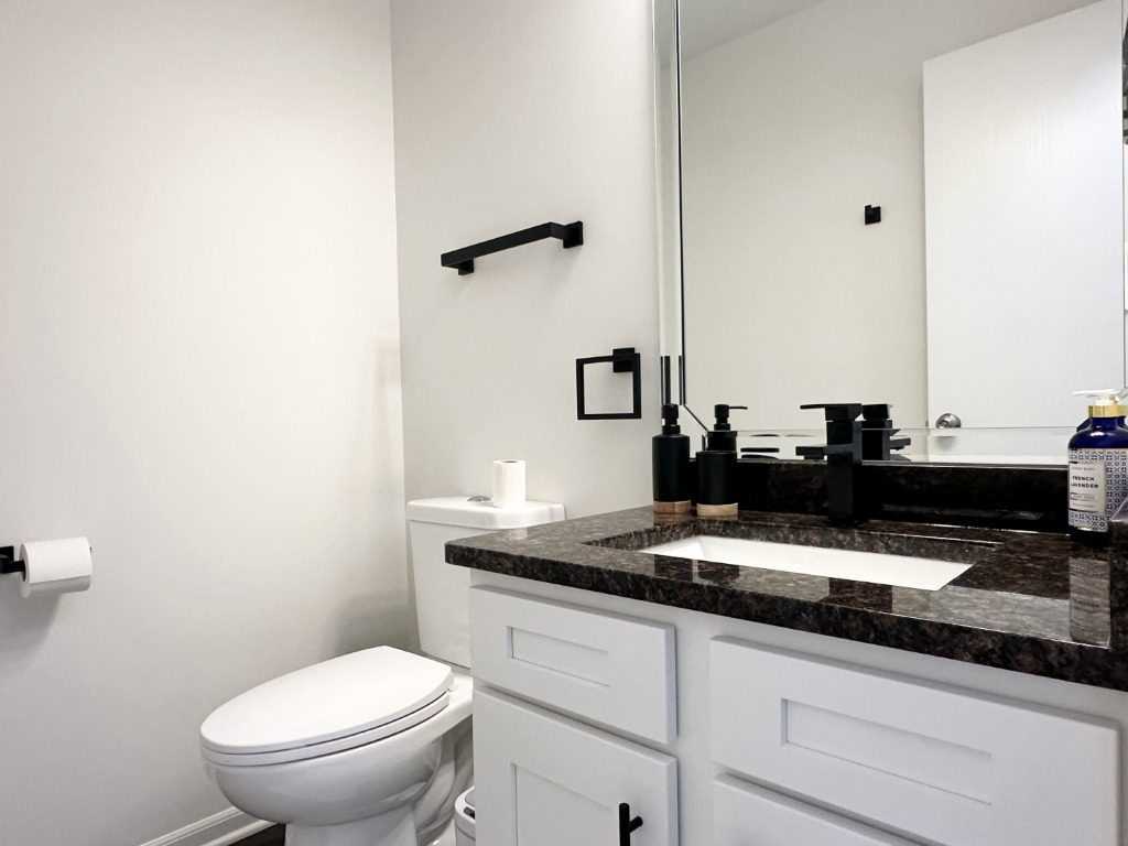 1514 Northfield Meadows Boulevard, Unit 2 Bourbonnais, IL 60914 - Photo 17 of 30 a bathroom with a granite countertop sink a toilet and a mirror