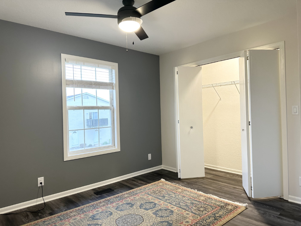 1514 Northfield Meadows Boulevard, Unit 2 Bourbonnais, IL 60914 - Photo 20 of 30 a view of an empty room with wooden floor and a window