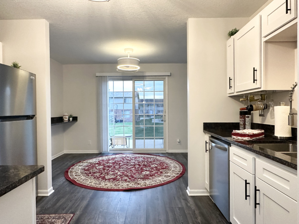 1514 Northfield Meadows Boulevard, Unit 2 Bourbonnais, IL 60914 - Photo 9 of 30 a kitchen with stainless steel appliances granite countertop a sink stove and refrigerator