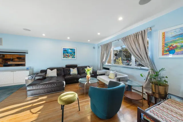 a living room with furniture a couch and large window