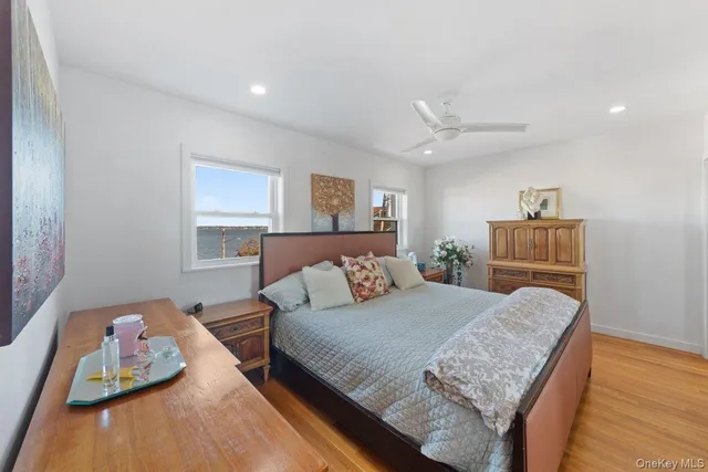 a bedroom with a bed and ceiling fan