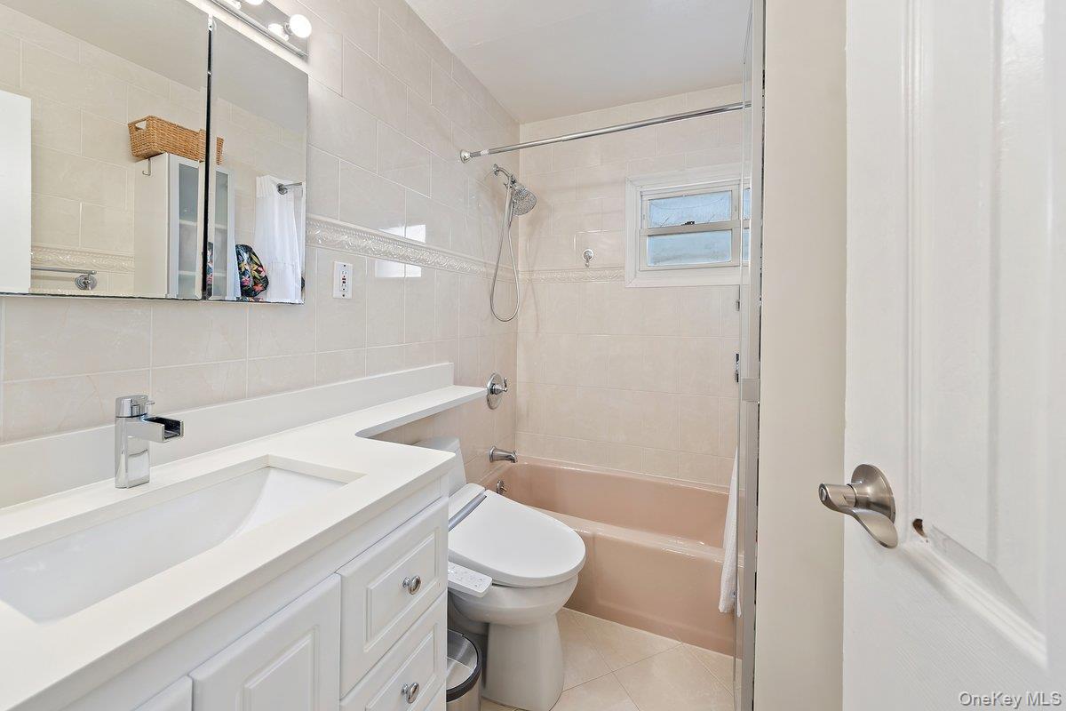 902 Dean Avenue Bronx, NY 10465 - Photo 19 of 40 a bathroom with a sink a toilet and shower