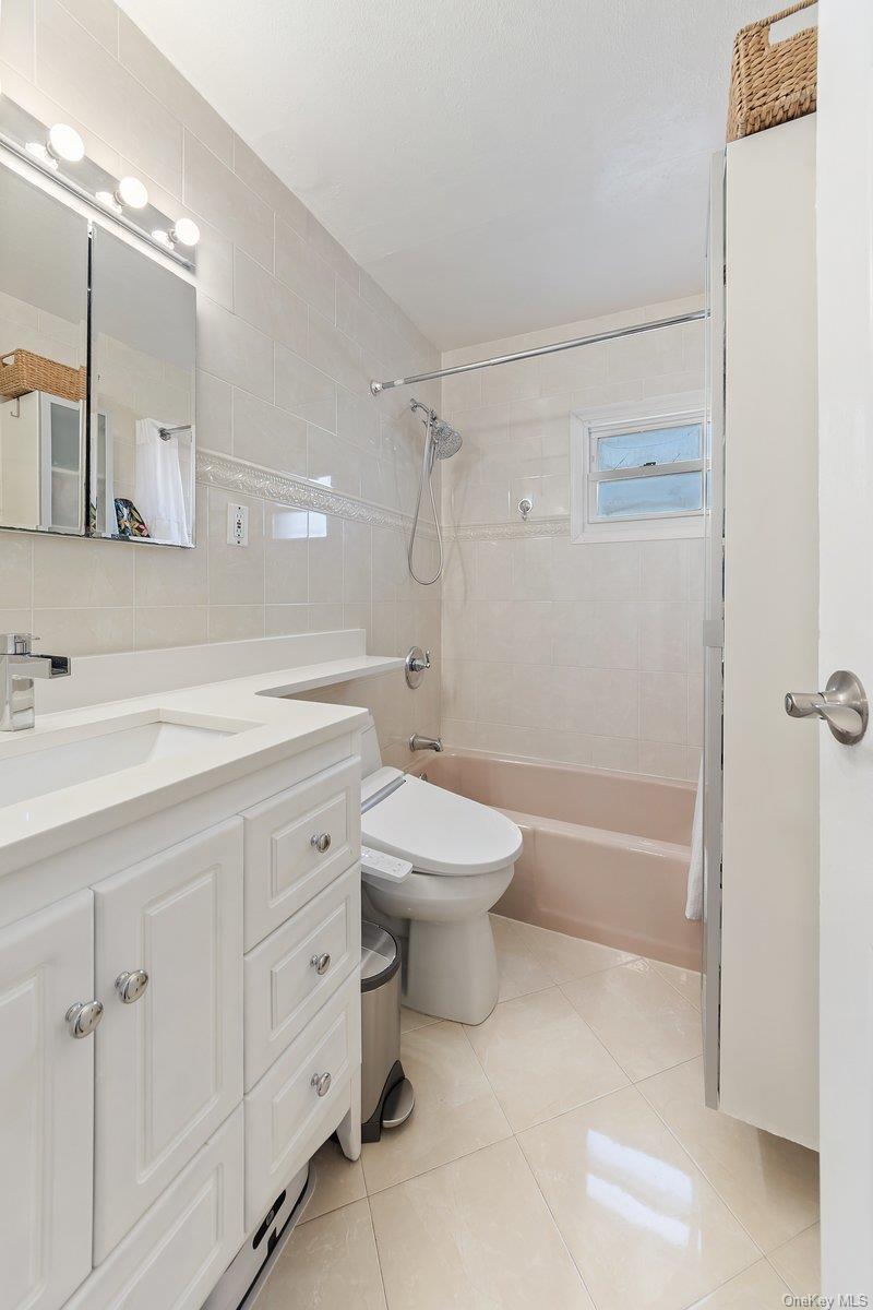 902 Dean Avenue Bronx, NY 10465 - Photo 20 of 40 a bathroom with a double vanity sink toilet mirror and shower