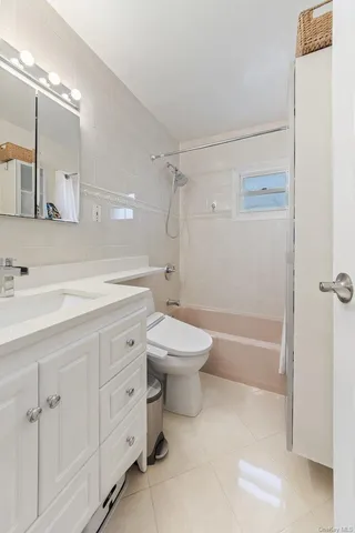a bathroom with a double vanity sink toilet mirror and shower