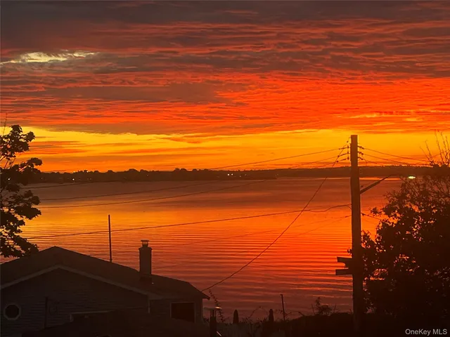 a view of a balcony with chair and wooden floor