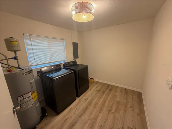 a view of a room with wooden floor