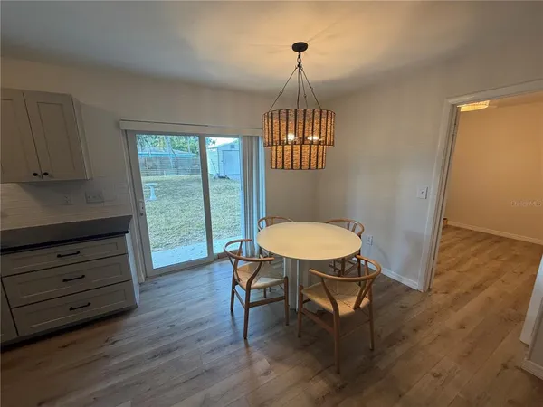 a view of a livingroom with furniture wooden floor a chandelier