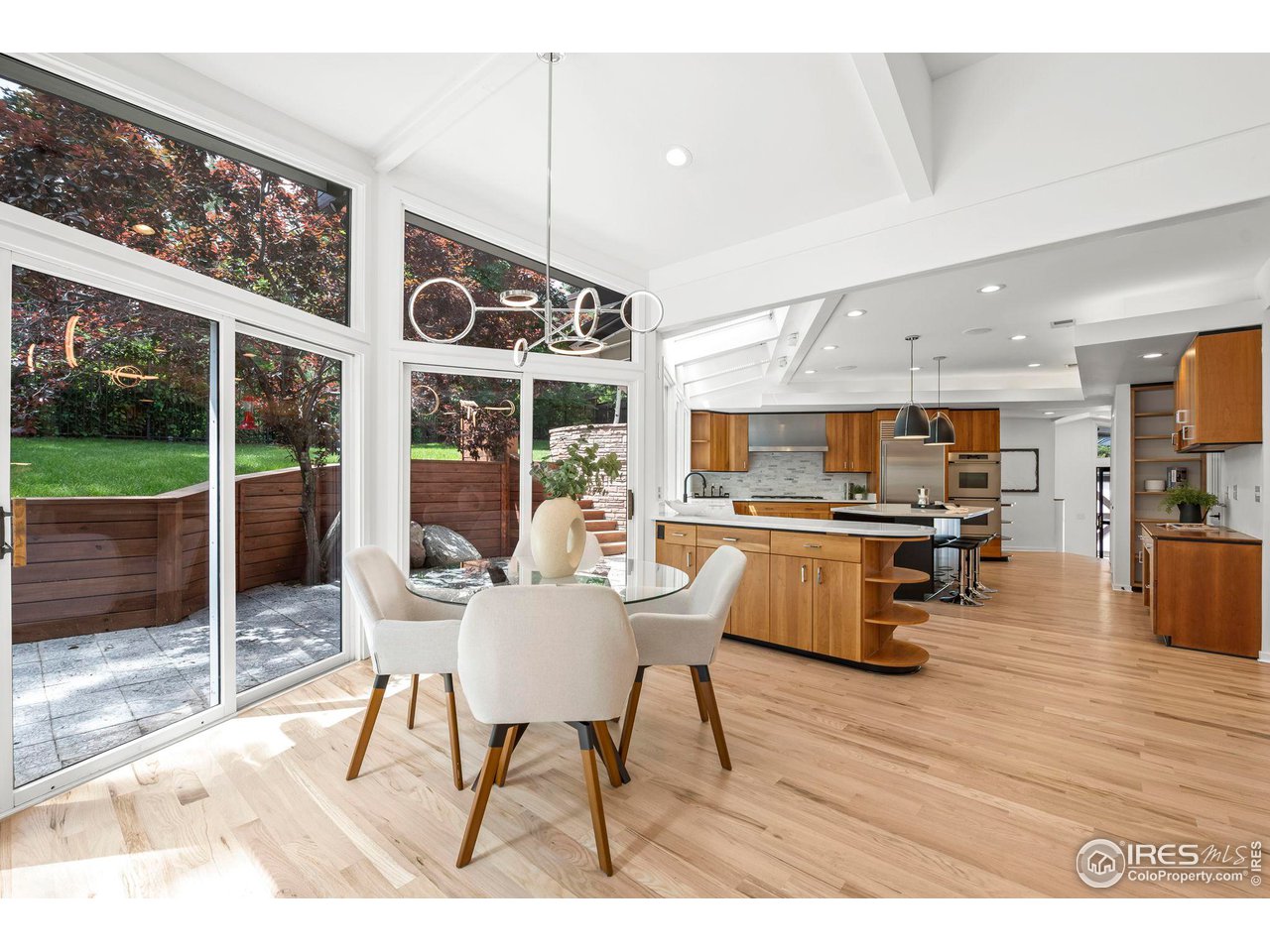 710 Willowbrook Road Boulder, CO 80302 - Photo 10 of 32 a dining room with wooden floor and large windows