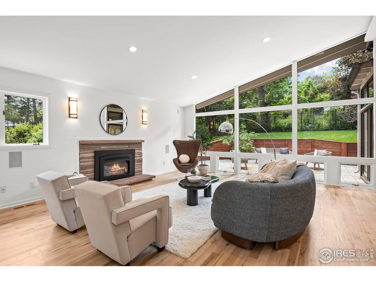 710 Willowbrook Road Boulder, CO 80302 - Photo 6 of 32 a living room with furniture a fireplace and a floor to ceiling window