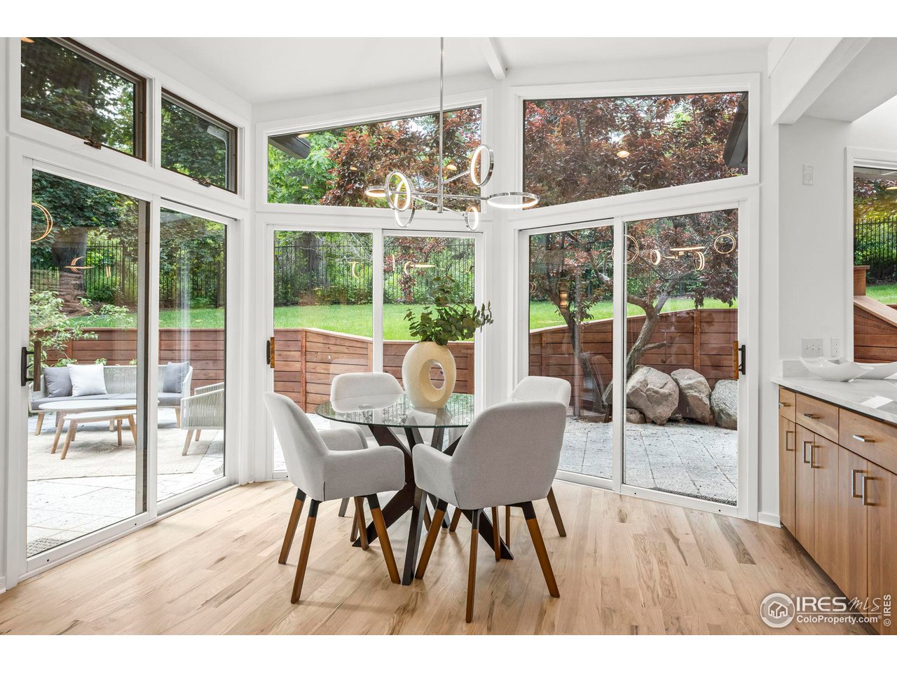 710 Willowbrook Road Boulder, CO 80302 - Photo 9 of 32 a dining room with furniture large windows and wooden floor