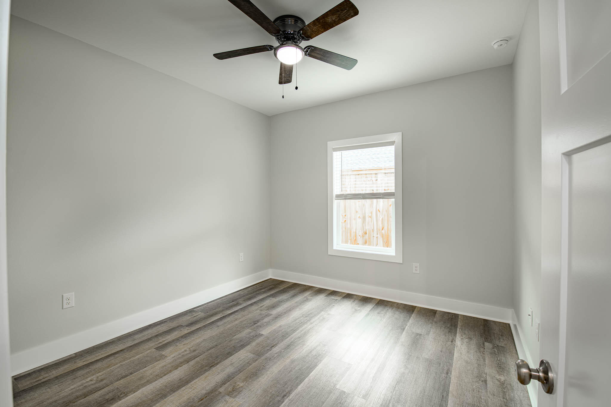 105 Clearing Way Valparaiso, FL 32580 - Photo 15 of 28 an empty room with wooden floor and windows