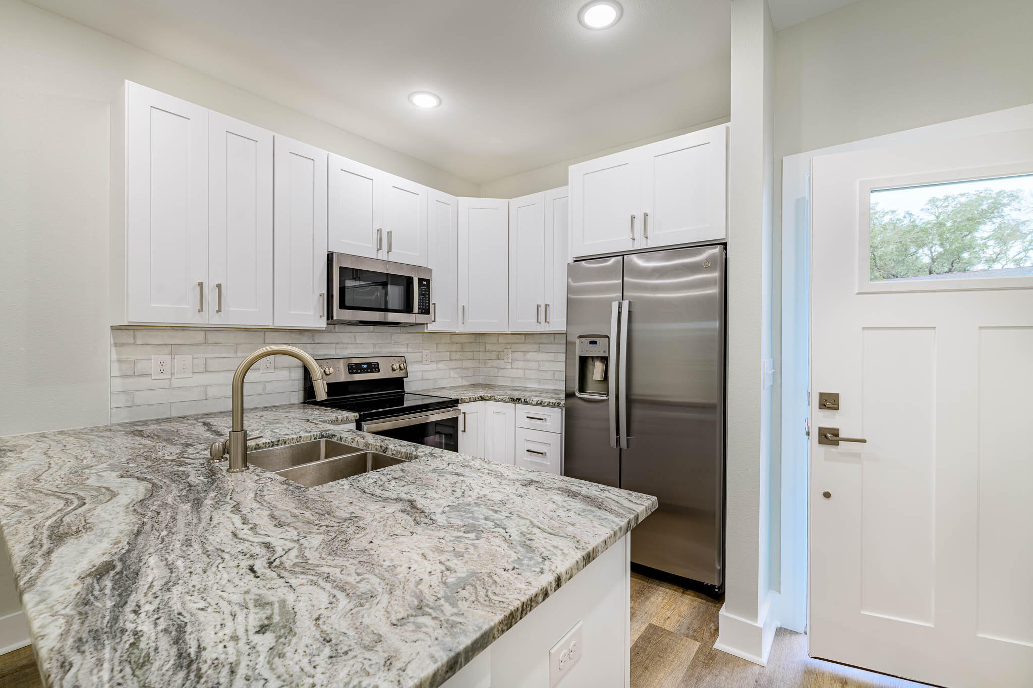 105 Clearing Way Valparaiso, FL 32580 - Photo 2 of 28 a kitchen with granite countertop a refrigerator and a stove top oven