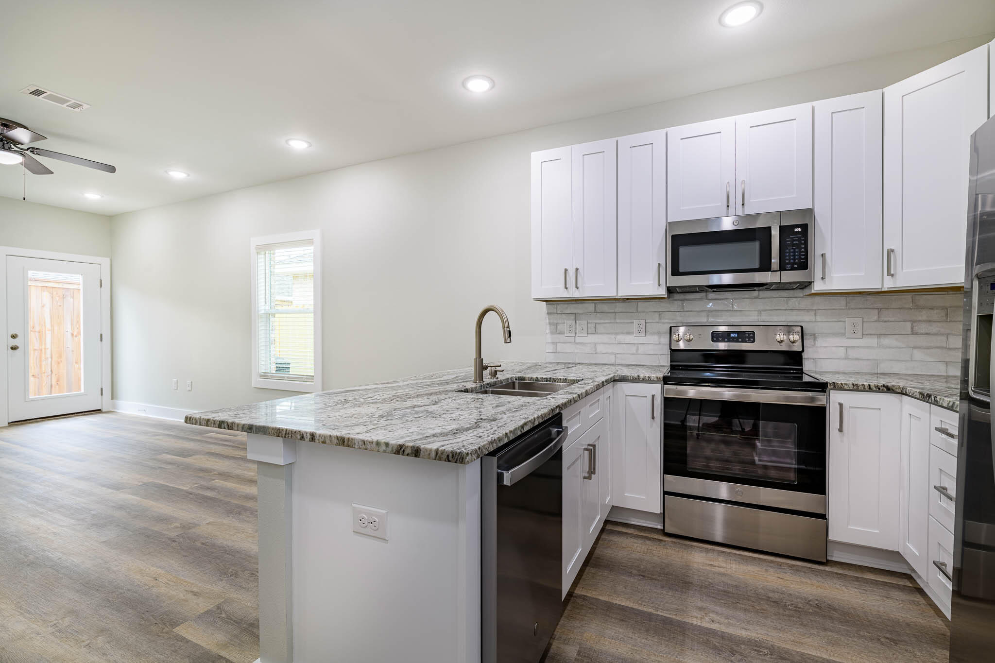 105 Clearing Way Valparaiso, FL 32580 - Photo 23 of 28 a kitchen with granite countertop a sink and stainless steel appliances
