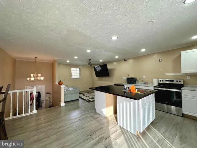 a kitchen with stainless steel appliances granite countertop a stove and a sink