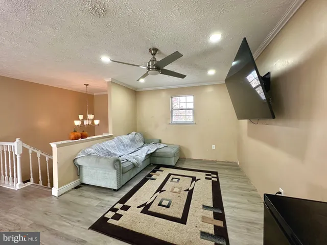 a living room with furniture and a chandelier