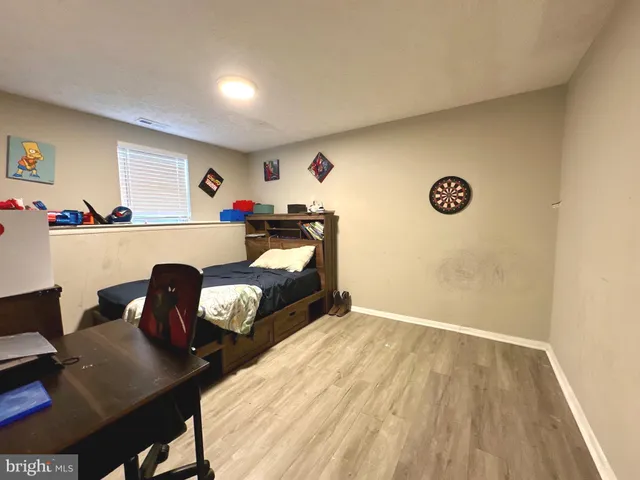 a bedroom with a bed and a desk