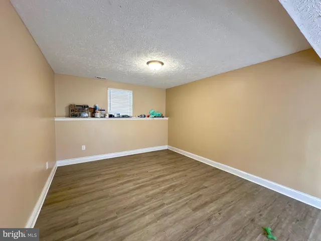 a view of a kitchen with wooden floor and a sink