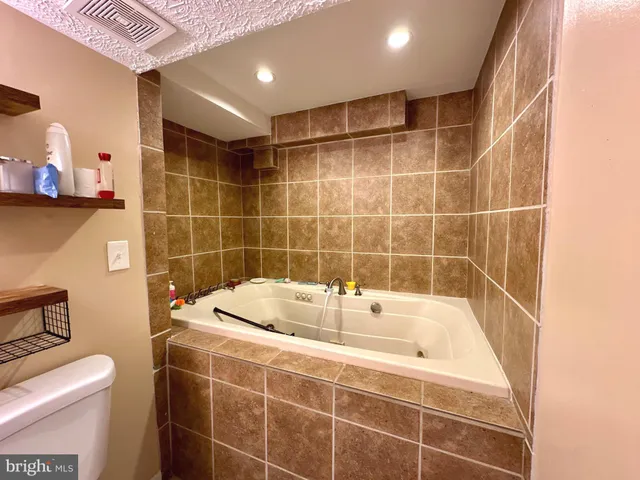 a bathroom with a bathtub and toilet