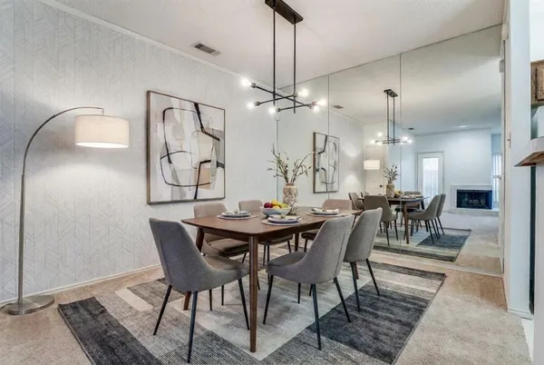 a view of a dining room with furniture and chandelier