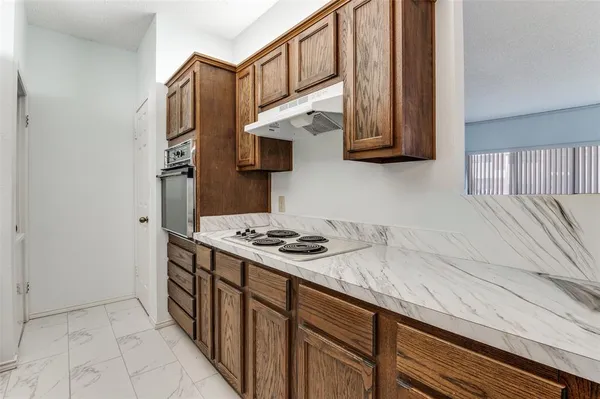 a kitchen with stainless steel appliances granite countertop a stove and a sink