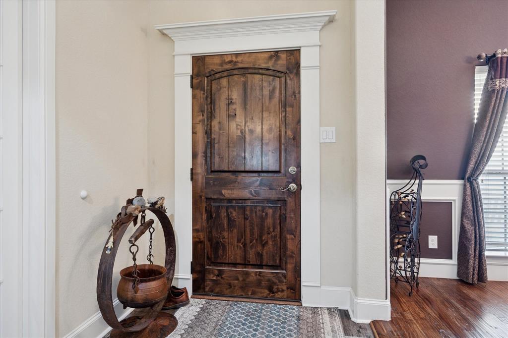 119 George Owens Road Ponder, TX 76259 - Photo 4 of 26 Distinguished wood-finish entry door with archtop paneling and white trim