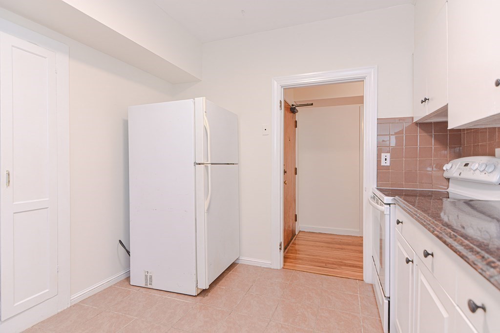 23 Warwick Road, Unit BF Brookline, MA 02445 - Photo 10 of 33 a view of a kitchen with an empty space and a kitchen