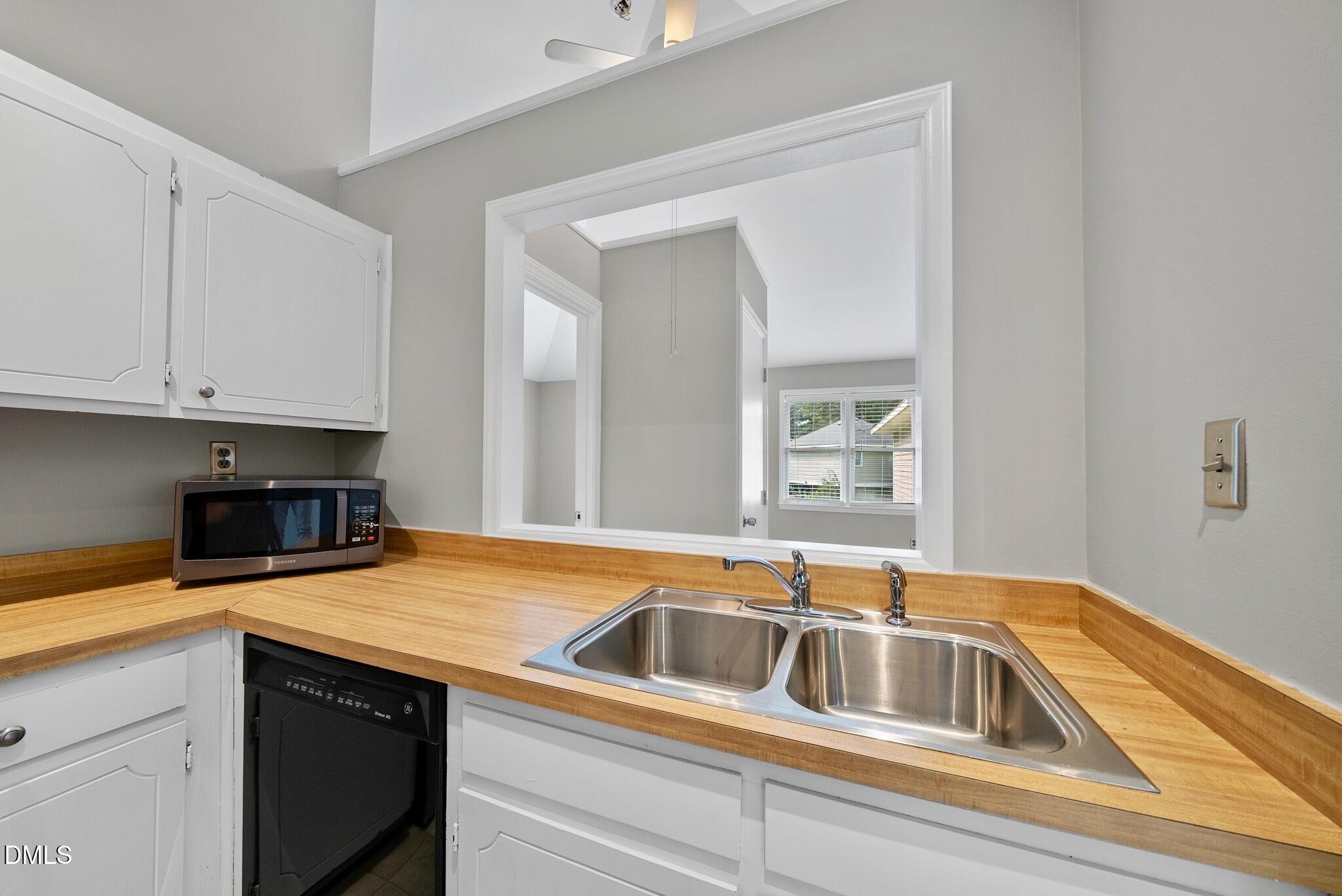 3634 Mill Run Raleigh, NC 27612 - Photo 10 of 18 a kitchen that has a sink and a stove