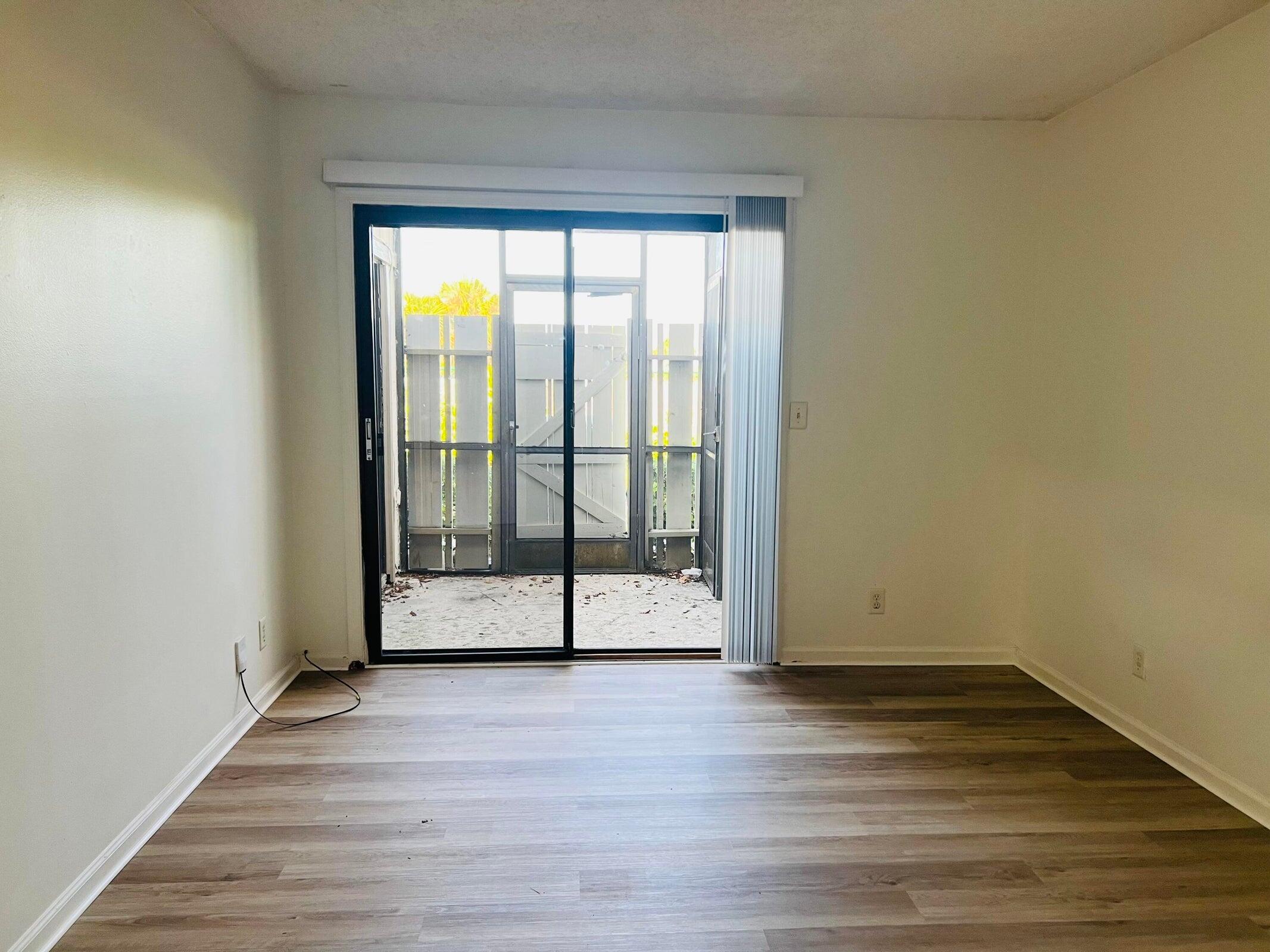 11877 Sturbridge Lane Wellington, FL 33414 - Photo 11 of 20 a view of an empty room with wooden floor and a window