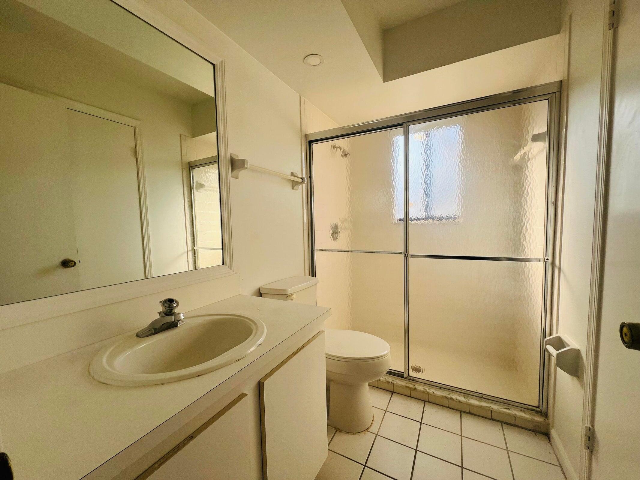 11877 Sturbridge Lane Wellington, FL 33414 - Photo 15 of 20 a bathroom with a sink and a shower