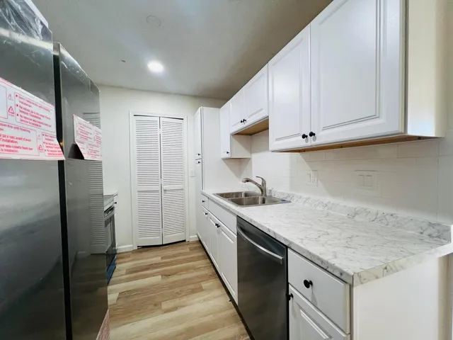a kitchen with a sink stove and refrigerator