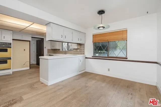 a view of cabinets with wooden floor and window