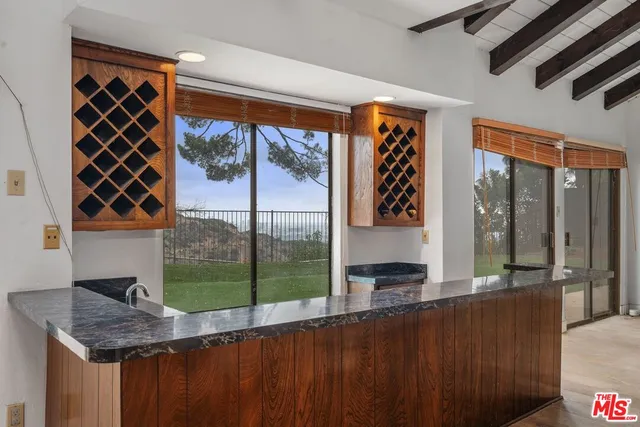 a bedroom with a large window and a bed