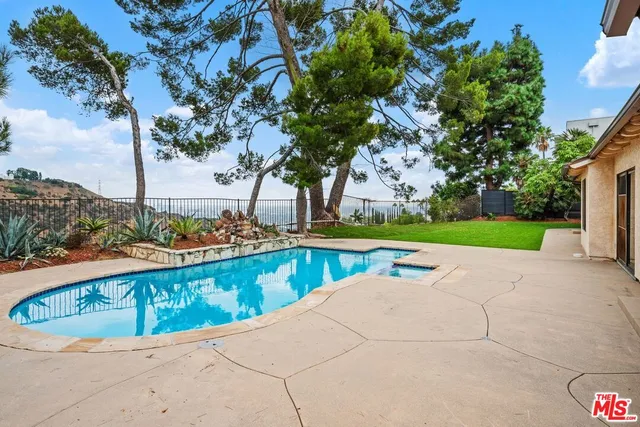 a view of swimming pool with outdoor seating and yard
