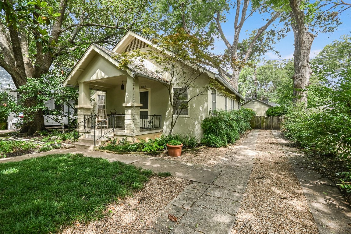 a front view of a house with a yard and porch