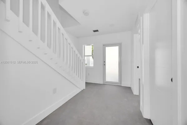 a view of a hallway with staircase