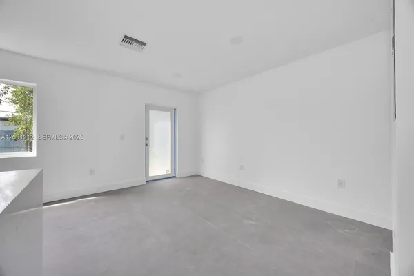 a view of an empty room and a window