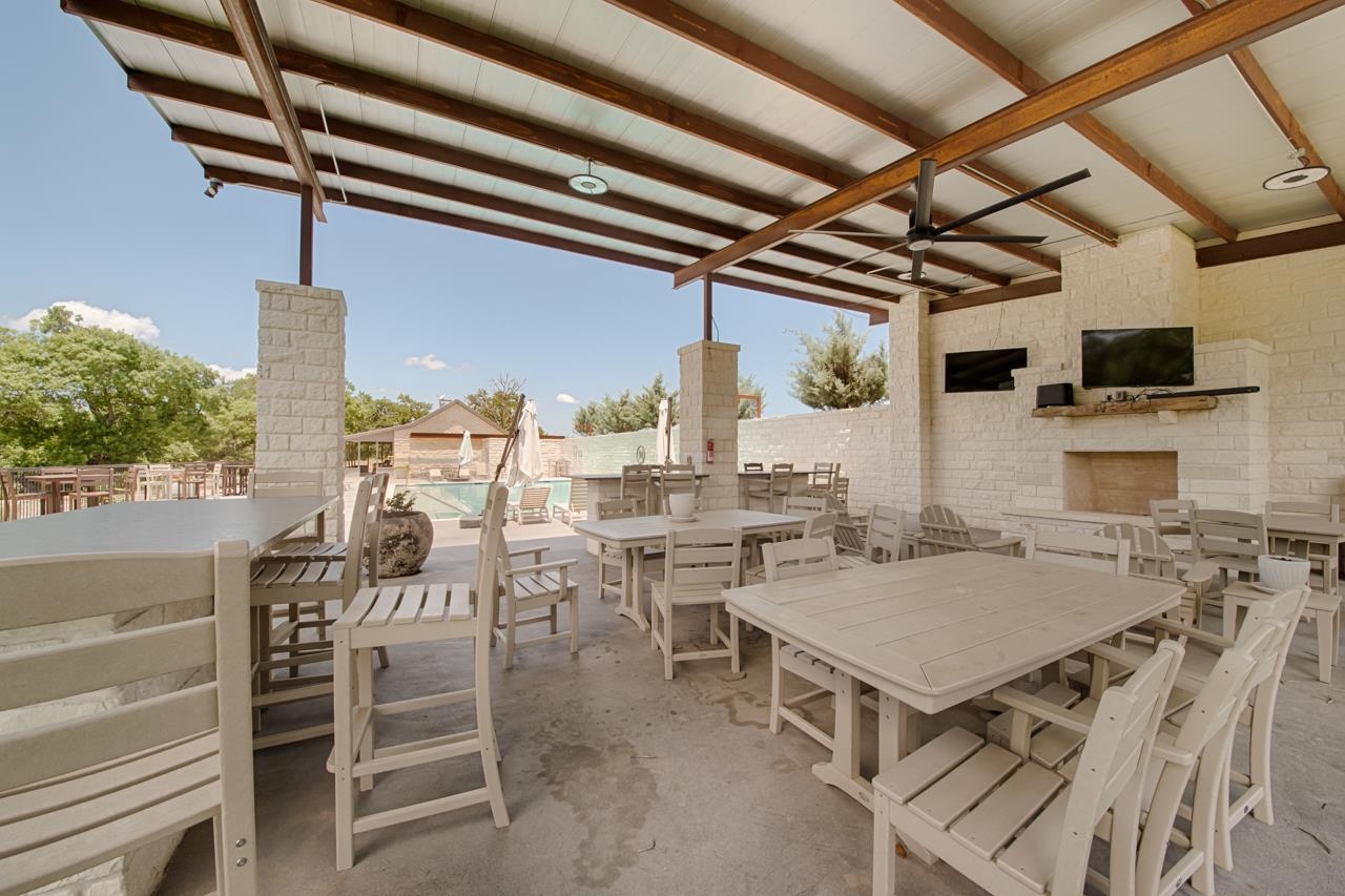 Lot 40 Pack Saddle Harper, TX 78631 - Photo 20 of 30 a view of a kitchen with a dining table chairs and a wooden floor