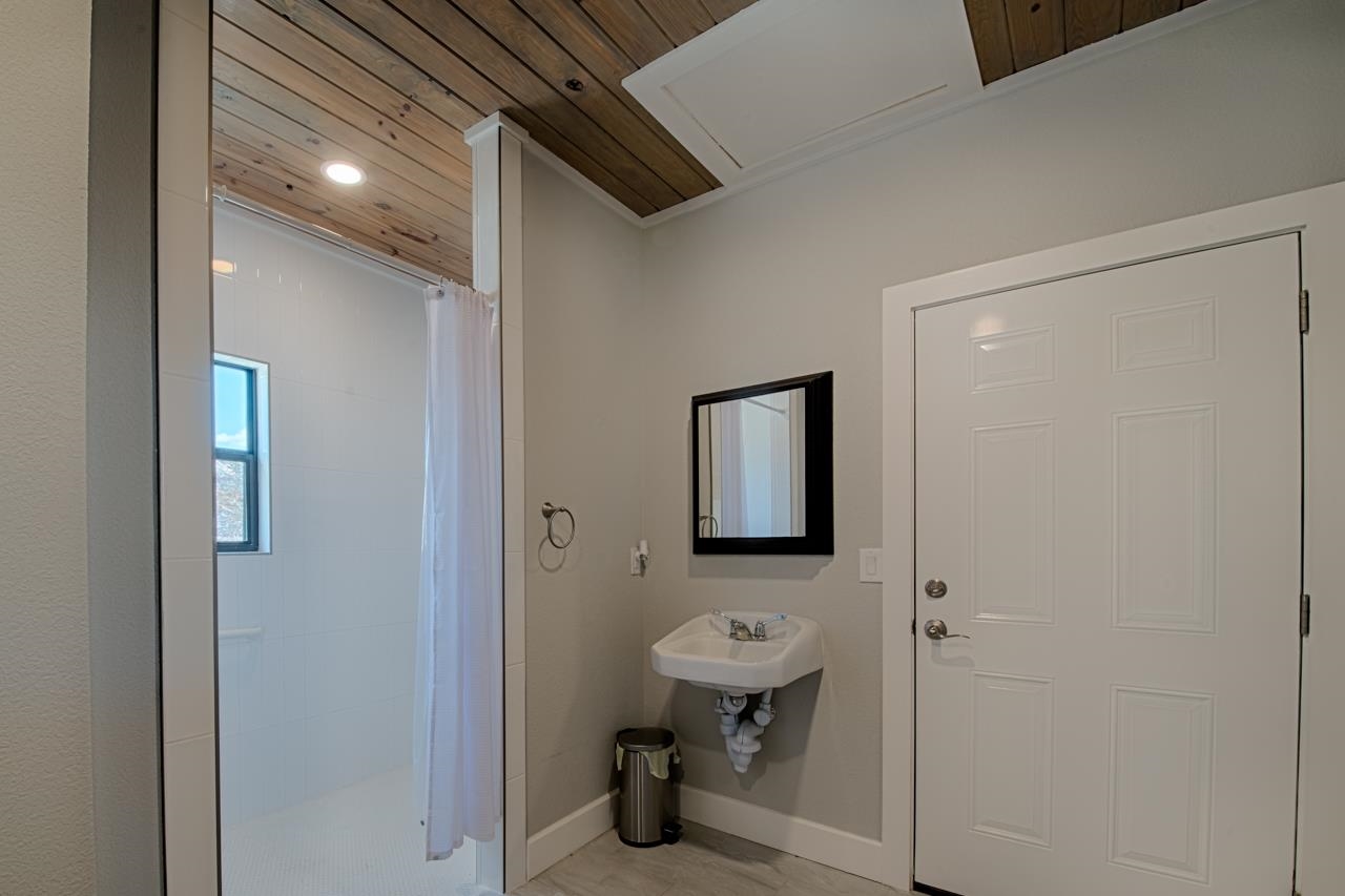 Lot 40 Pack Saddle Harper, TX 78631 - Photo 24 of 30 a bathroom with a sink a toilet and shower