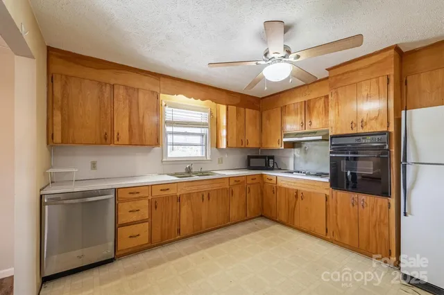 a kitchen with a sink appliances and cabinets